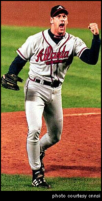 Atlanta Braves pitcher John Rocker raises a defient fist to the crowd.