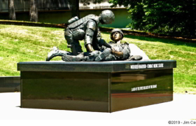 A medic attends to a wounded warrior at a new display staged at Huntsville Veteran's Memorial.