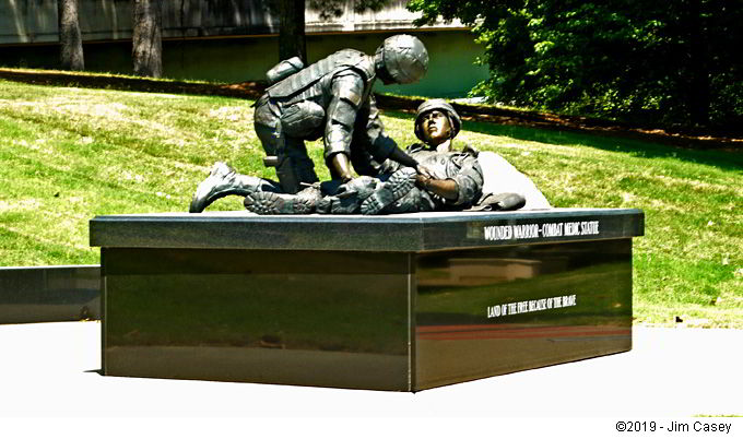 A medic attends to a wounded warrior at a new display staged at Huntsville Veteran's Memorial.