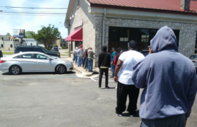 Folks line up for booze at the Alabama State Store following social distancing guidelines.