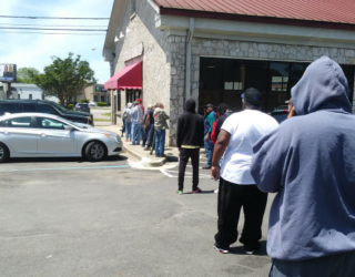 Folks line up for booze at the Alabama State Store following social distancing guidelines.