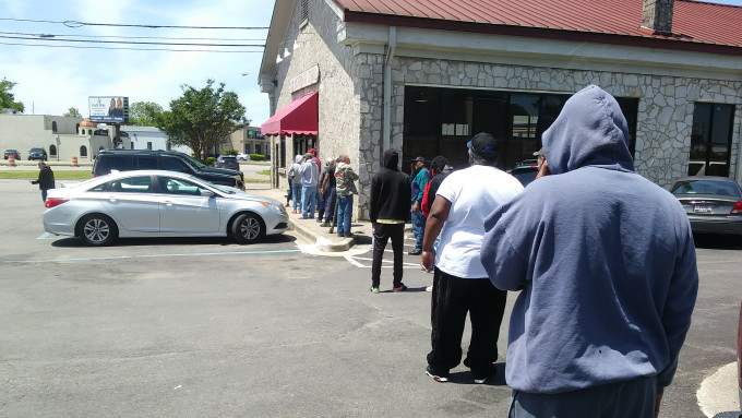 Folks line up for booze at the Alabama State Store following social distancing guidelines.