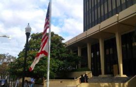 The flags fly at half staff in front of the Madison County Courthouse where an empty space remains in place of Huntsville's confederate monument. The flags have been lowered to honor Mayor Tommy Battles wife Eula, who will be laid to rest today, also in Maple Hill Cemetery.