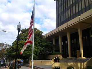 The flags fly at half staff in front of the Madison County Courthouse where an empty space remains in place of Huntsville's confederate monument. The flags have been lowered to honor Mayor Tommy Battles wife Eula, who will be laid to rest today, also in Maple Hill Cemetery.