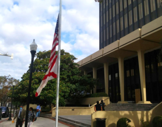 The flags fly at half staff in front of the Madison County Courthouse where an empty space remains in place of Huntsville's confederate monument. The flags have been lowered to honor Mayor Tommy Battles wife Eula, who will be laid to rest today, also in Maple Hill Cemetery.
