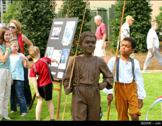 This youngun appears to be mocking a depiction at the dedication of Huntsville's Bicentennial Park in 2005 of a boy in the 1800's who went fishing instead of picking cotton.