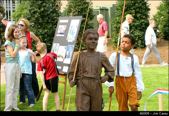 This youngun appears to be mocking a depiction at the dedication of Huntsville's Bicentennial Park in 2005 of a boy in the 1800's who went fishing instead of picking cotton.