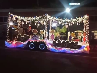 Christmas 2023 float decorated with bright lights and the Peanuts kids.