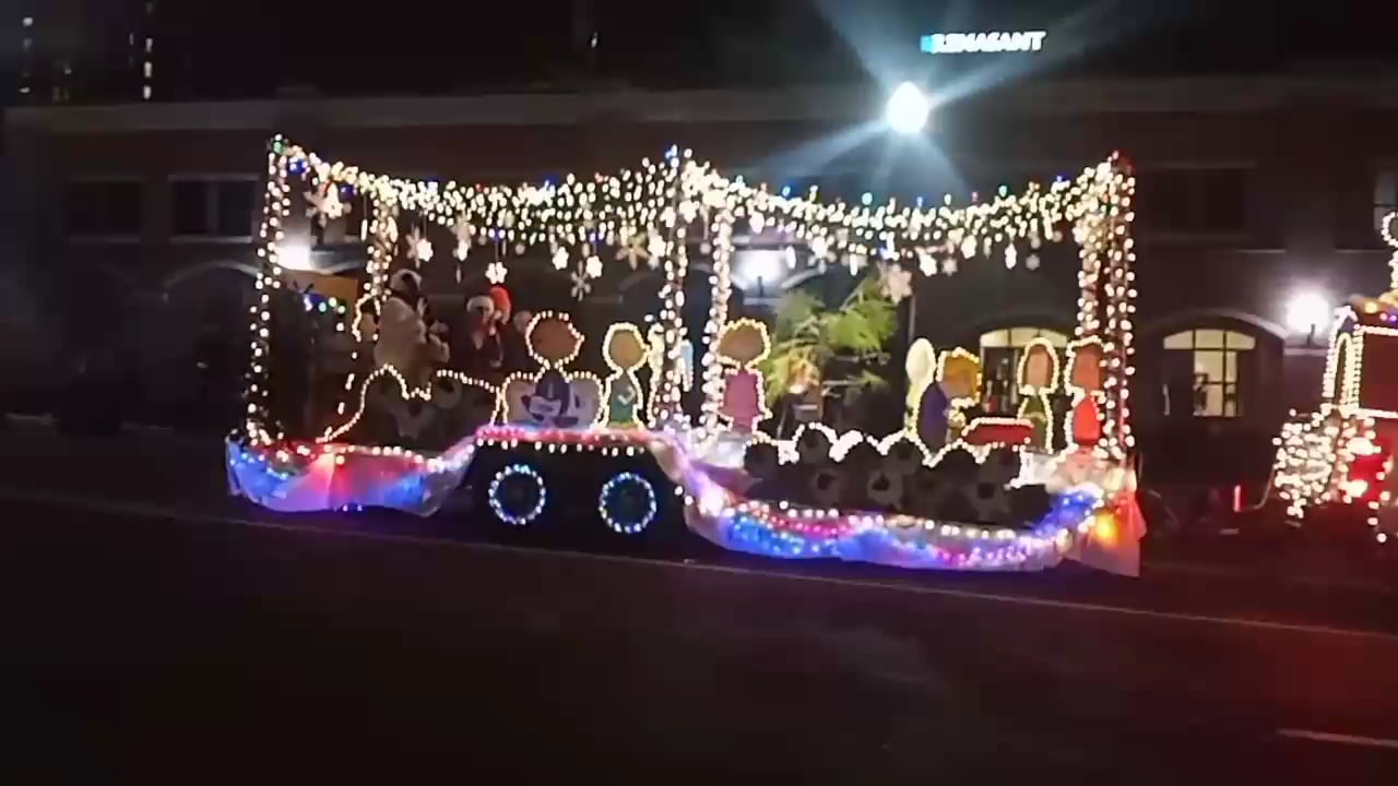 Christmas 2023 float decorated with bright lights and the Peanuts kids.