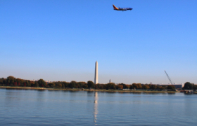 A colorful SouthWest airlines jet above the Washington Monument as seen from Arlington in October 2024.