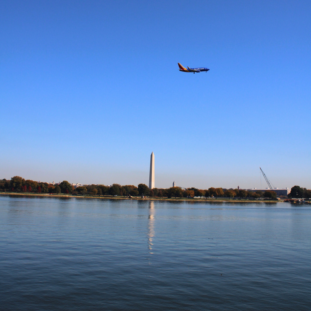 A colorful SouthWest airlines jet above the Washington Monument as seen from Arlington in October 2024.