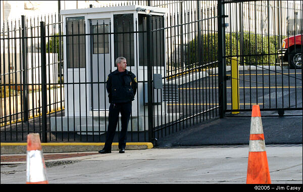 An officer stands in front of the newly installed guard shack and fence at the Federal Courthouse. These security measures were apparently inspired in part by Rudolph's first Huntsville visit last summer.